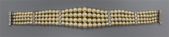 A triple strand cultured pearl bracelet with four white metal and diamond set spacers, 18.5cm.